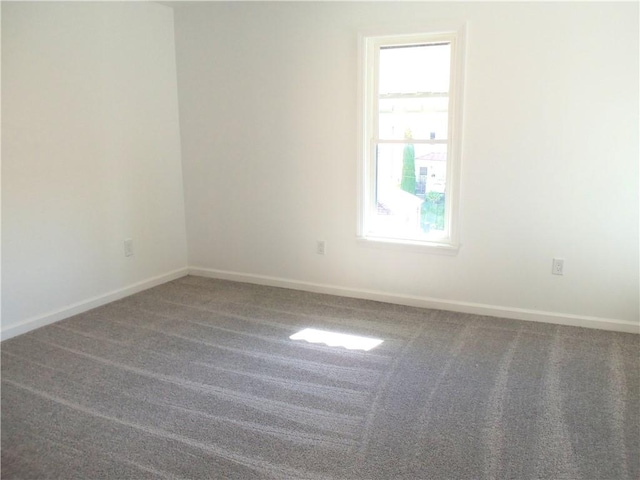 carpeted spare room featuring plenty of natural light