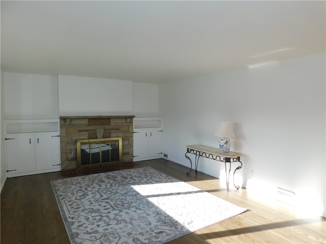 unfurnished living room with dark hardwood / wood-style floors and a fireplace