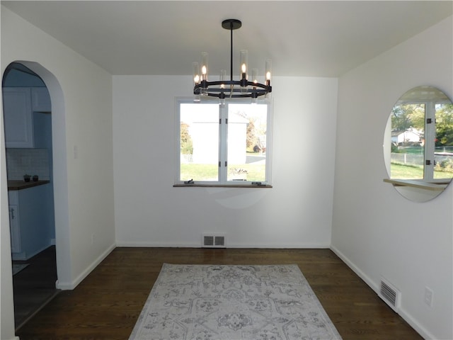 dining space with a chandelier and dark hardwood / wood-style floors