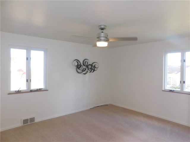 unfurnished room with ceiling fan and light colored carpet