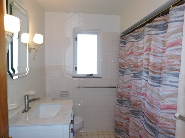 bathroom featuring tile walls, toilet, vanity, tile patterned floors, and a shower with shower curtain