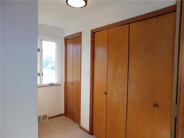 hallway with light colored carpet