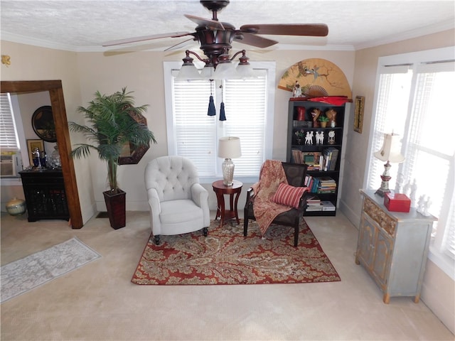 sitting room featuring crown molding, a textured ceiling, light colored carpet, and plenty of natural light