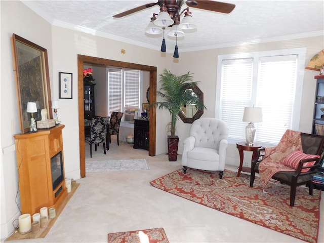 sitting room featuring light carpet, ceiling fan, cooling unit, a textured ceiling, and ornamental molding