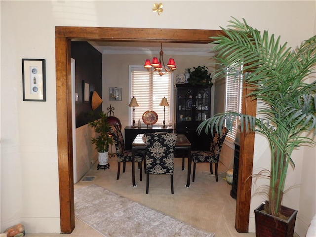 carpeted dining room with a notable chandelier