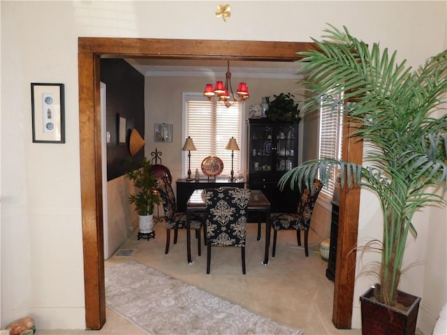 58 Mullen St, South Union Twp, PA 15401 - dining space featuring carpet flooring, crown molding, visible vents, and a notable chandelier