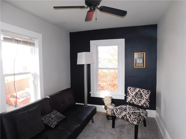 sitting room featuring ceiling fan and carpet