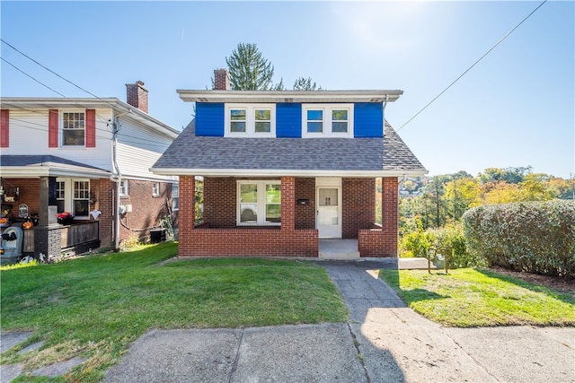 view of front of property with a porch, a front yard, and central AC unit