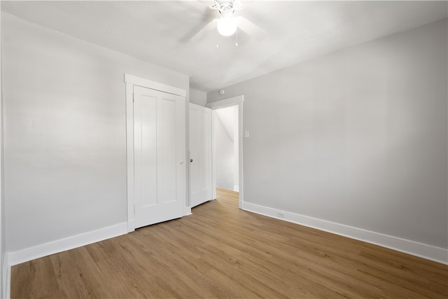 unfurnished bedroom with light hardwood / wood-style floors, a closet, and ceiling fan