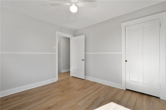 unfurnished bedroom with light wood-type flooring and ceiling fan