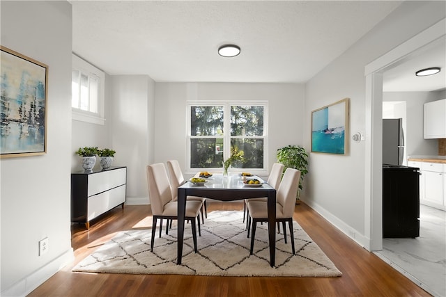 dining space with light hardwood / wood-style flooring