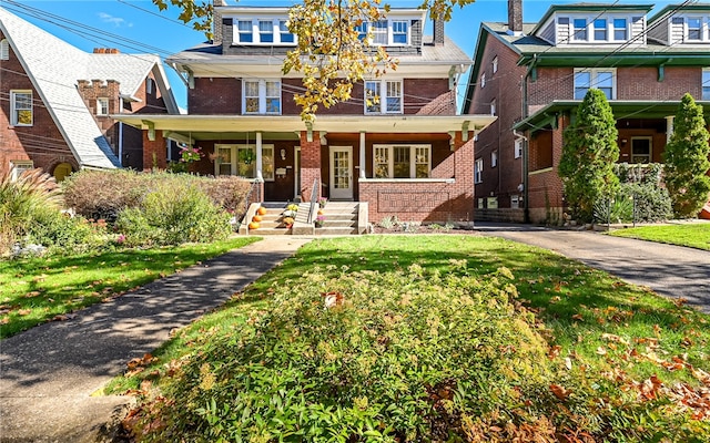 view of front of home featuring a porch and a front lawn