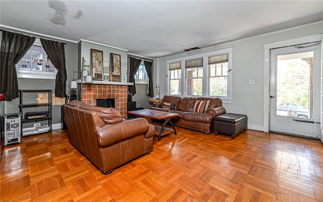 living room featuring parquet floors, a tile fireplace, and a wealth of natural light