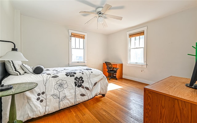 bedroom with light hardwood / wood-style flooring and ceiling fan