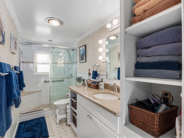 bathroom featuring vanity, an enclosed shower, toilet, and crown molding