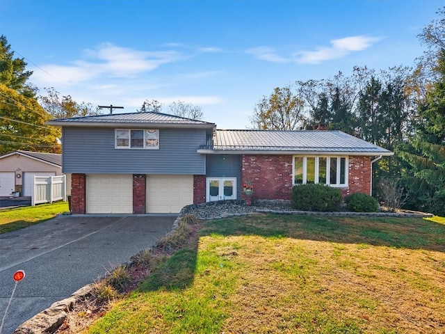 split level home featuring a front yard and a garage