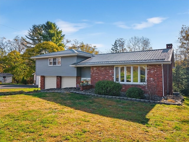 split level home with a front yard and a garage