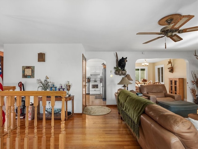 living room featuring light hardwood / wood-style floors and ceiling fan