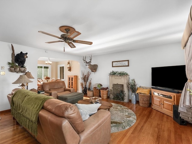 living room with hardwood / wood-style floors and ceiling fan