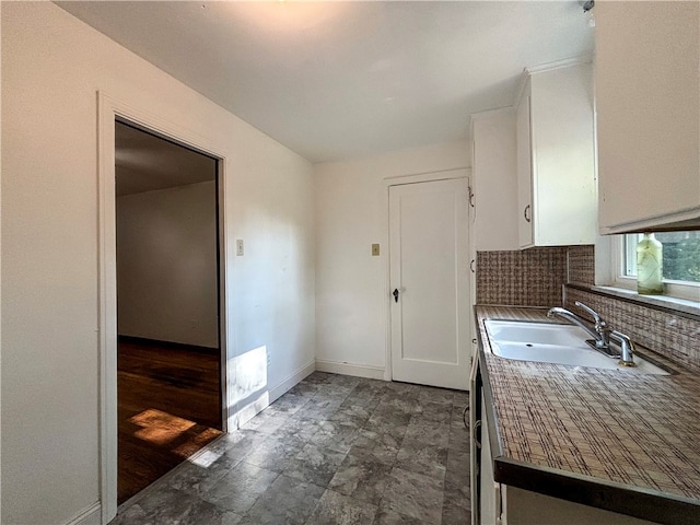 kitchen with dark wood-type flooring, sink, and white cabinets