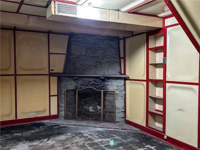 basement with a stone fireplace