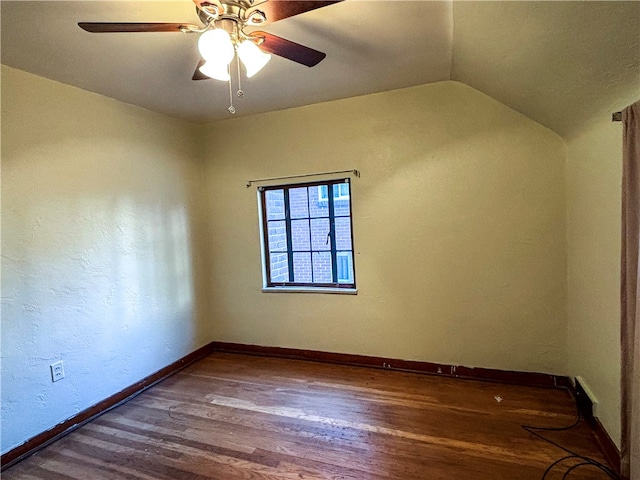 unfurnished room with hardwood / wood-style flooring, ceiling fan, and vaulted ceiling