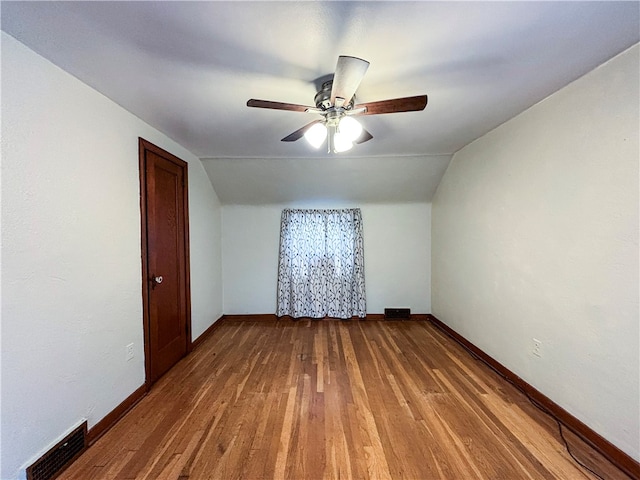 bonus room with hardwood / wood-style flooring, ceiling fan, and vaulted ceiling