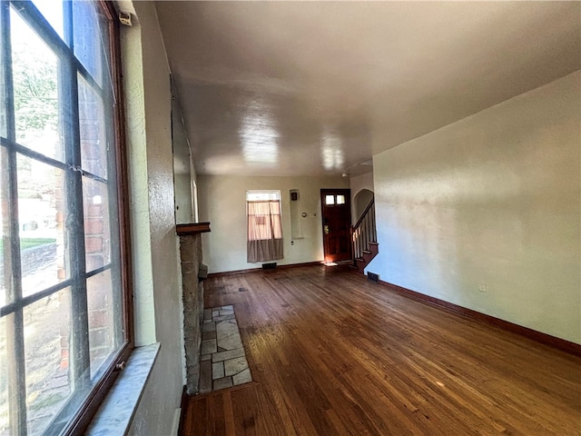 unfurnished living room with a fireplace and dark hardwood / wood-style floors