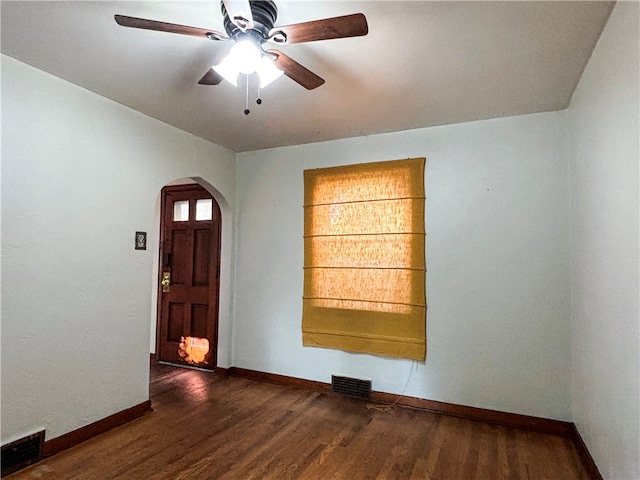 interior space with ceiling fan and dark hardwood / wood-style flooring