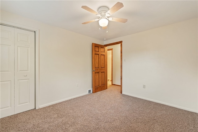 unfurnished bedroom featuring a closet, ceiling fan, and carpet flooring