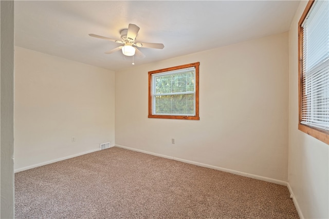 empty room with ceiling fan and carpet