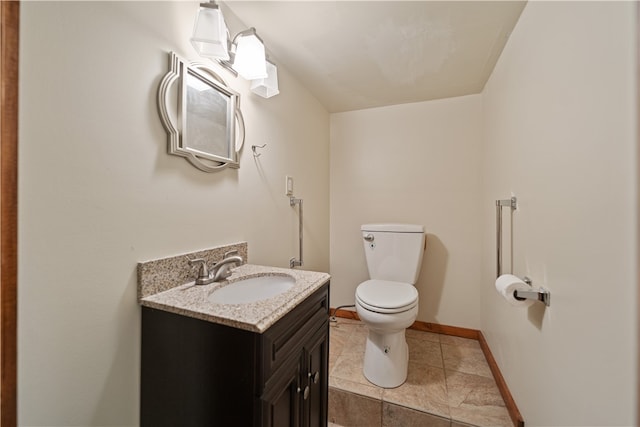 bathroom with vanity, toilet, and tile patterned flooring