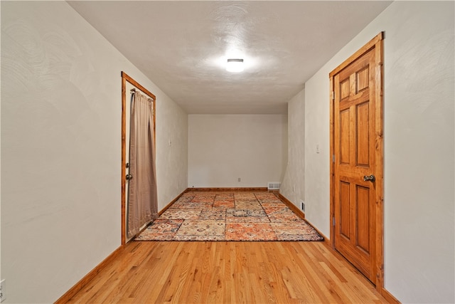 hallway with light wood-type flooring