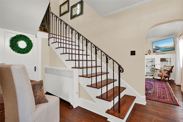 staircase with hardwood / wood-style flooring and radiator