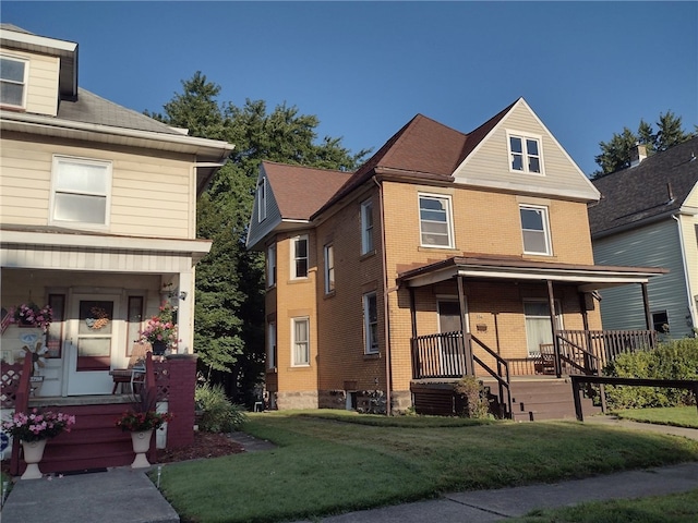 view of front of house with a porch and a front lawn