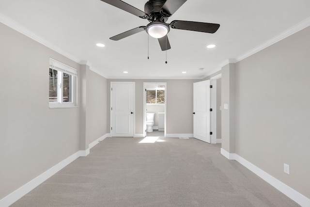 carpeted empty room featuring crown molding and ceiling fan