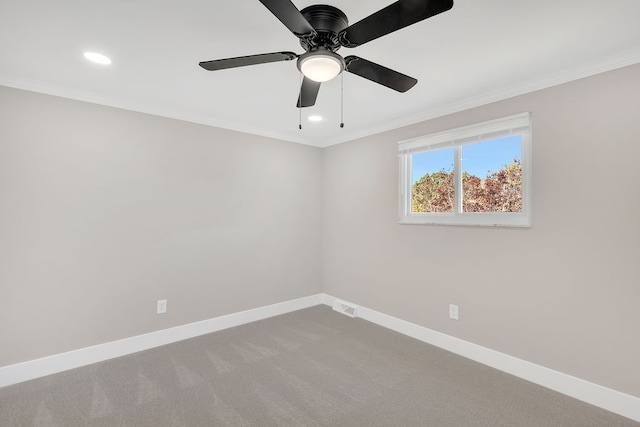 carpeted spare room featuring crown molding and ceiling fan