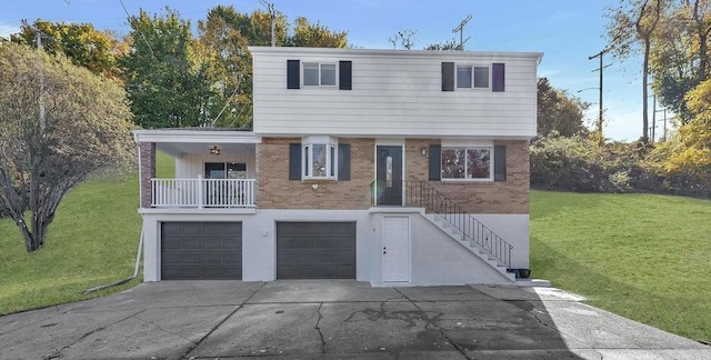 view of front facade featuring driveway, brick siding, an attached garage, and a front lawn