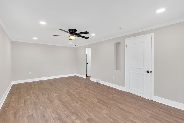 spare room with crown molding, light hardwood / wood-style floors, and ceiling fan