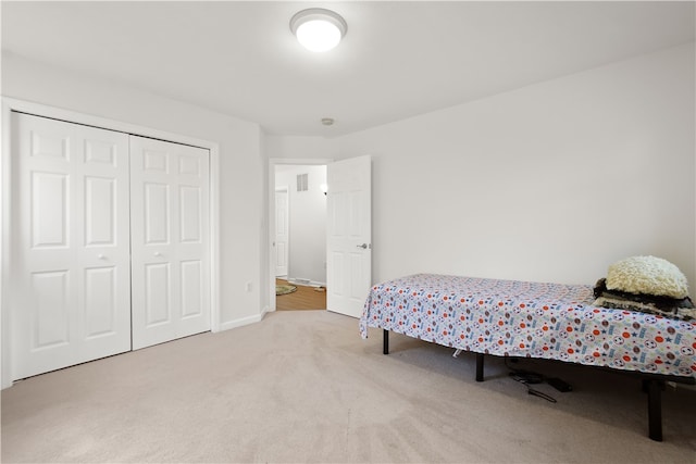 carpeted bedroom with a closet