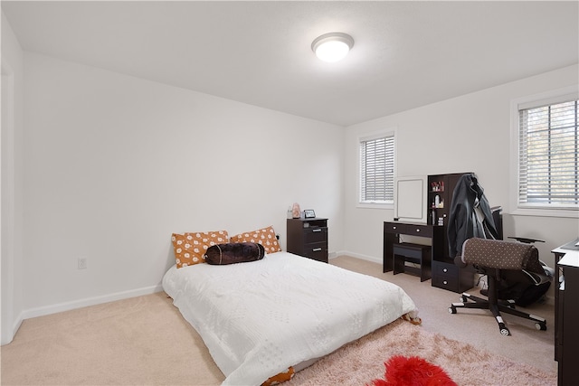 carpeted bedroom featuring multiple windows