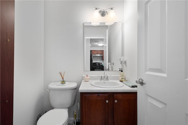 bathroom featuring vanity and toilet