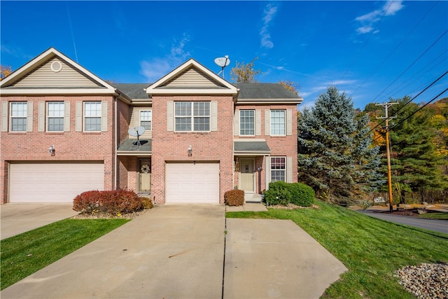 view of front of home featuring a front yard and a garage