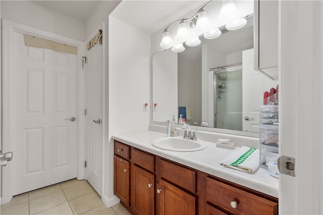 bathroom with tile patterned floors, vanity, and an enclosed shower