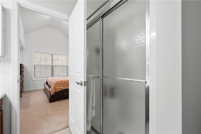 bathroom with vanity, an enclosed shower, and vaulted ceiling