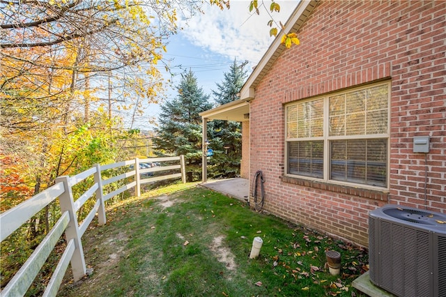 view of yard featuring central air condition unit and a patio