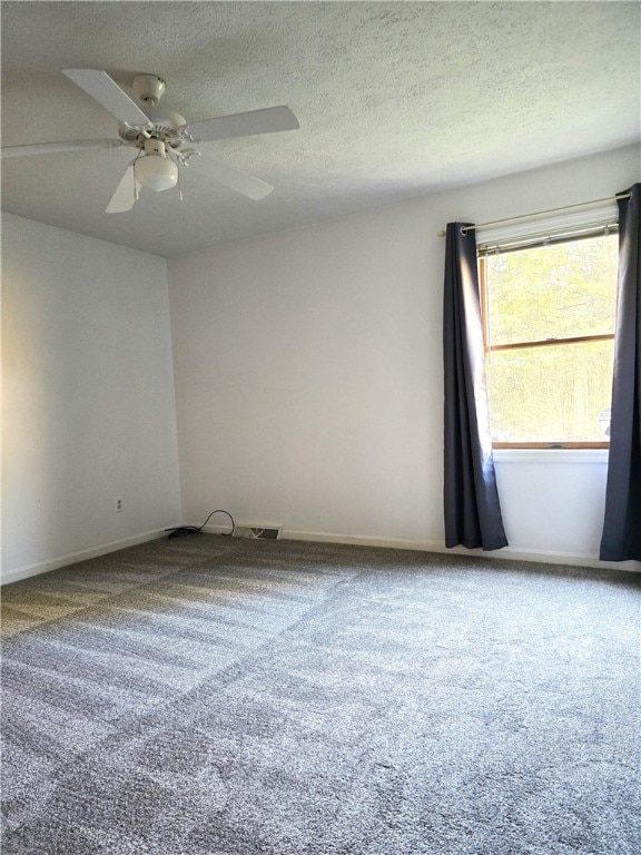 carpeted empty room with a textured ceiling and ceiling fan