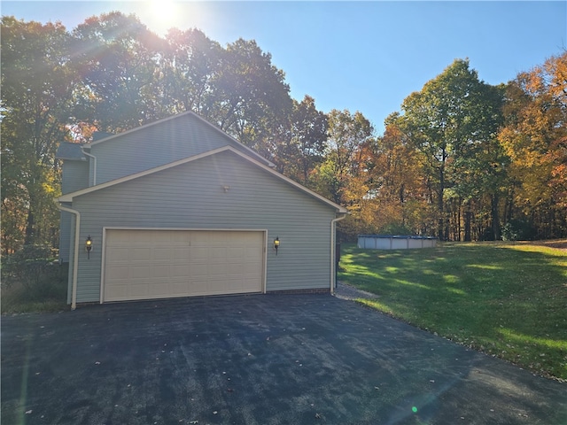 view of property exterior featuring a yard and a garage