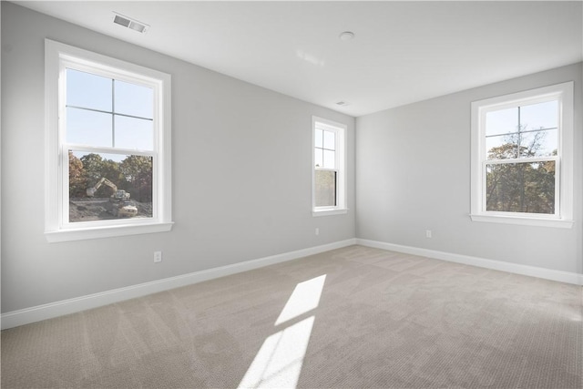 carpeted empty room with plenty of natural light