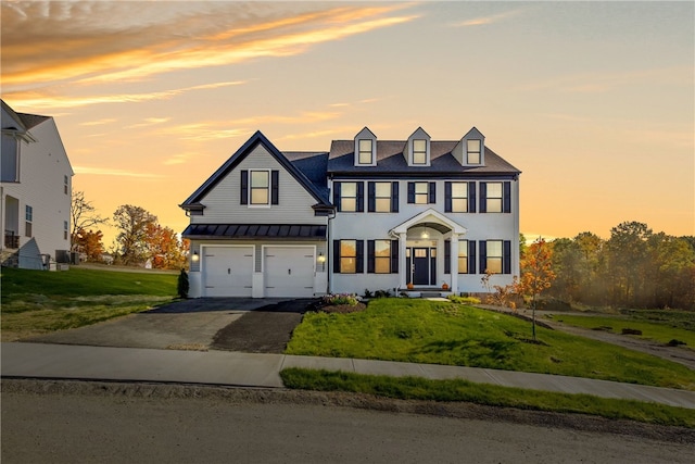 view of front of house featuring a lawn and a garage